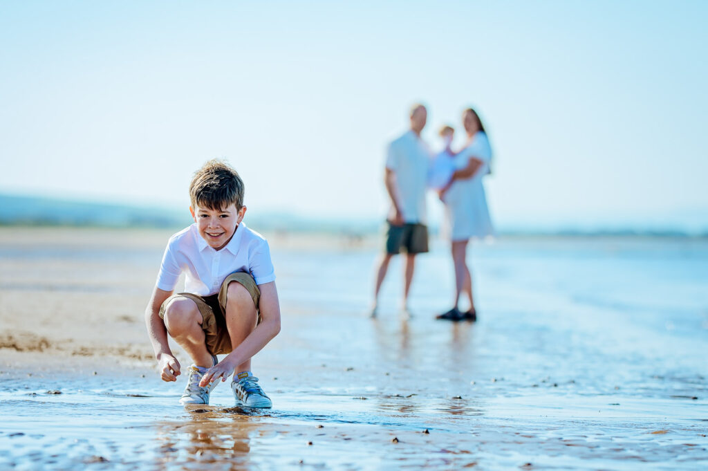 Boy posing for a family photographer Ola Molik Photography during their family photoshoot in Irvine Scotland