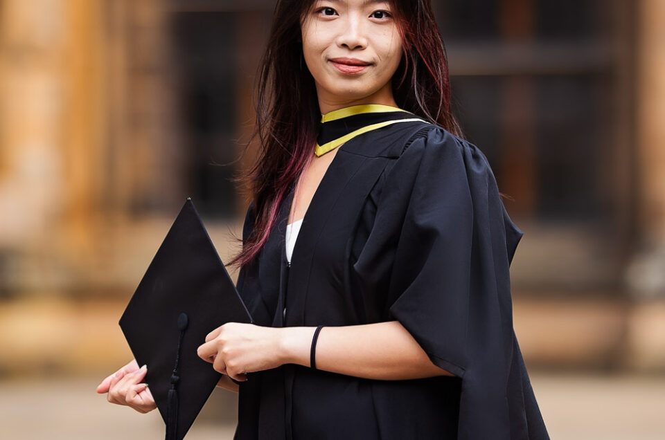 Graduating student posing for a photographer Ola Molik Photography during her graduation ceremony at University of Glasgow