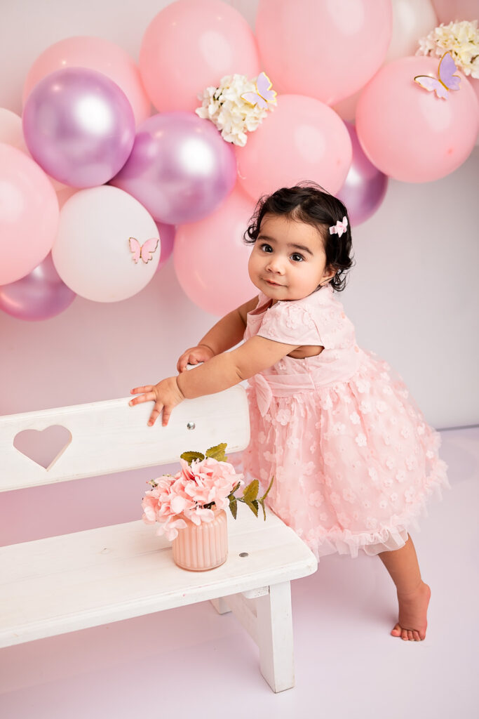 baby girl standing and posing for a photographer Ola Molik photography