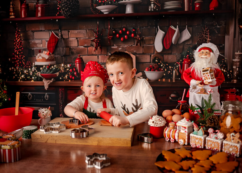 Children posing for a photographer during their Christmas Kitchen Mini Photoshoot in Glasgow