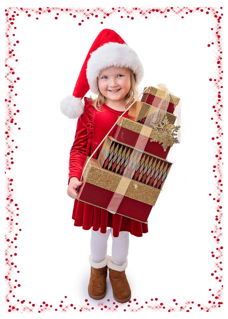Little girl holding Christmas presents during her Christmas Photoshoot with Ola Molik Photography