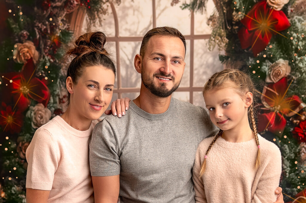Family Posing to the camera during their Christmas photoshoot with Ola Molik Photography In Glasgow