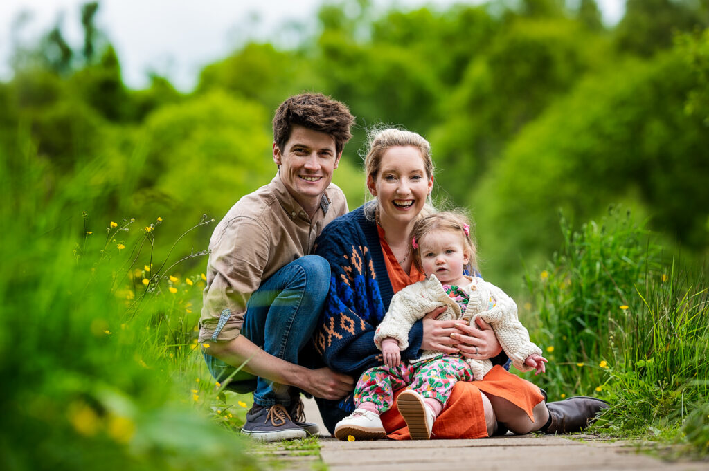 Parents holding daughter during their family photoshoot on location in Mugdock Park Glasgow