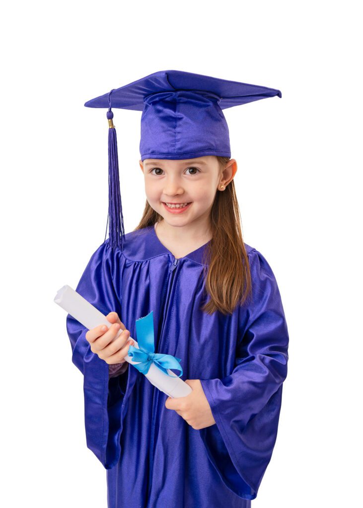 Nursery graduation portrait of smiling preschool girl wearing a blue graduation gown in a Glasgow photography studio