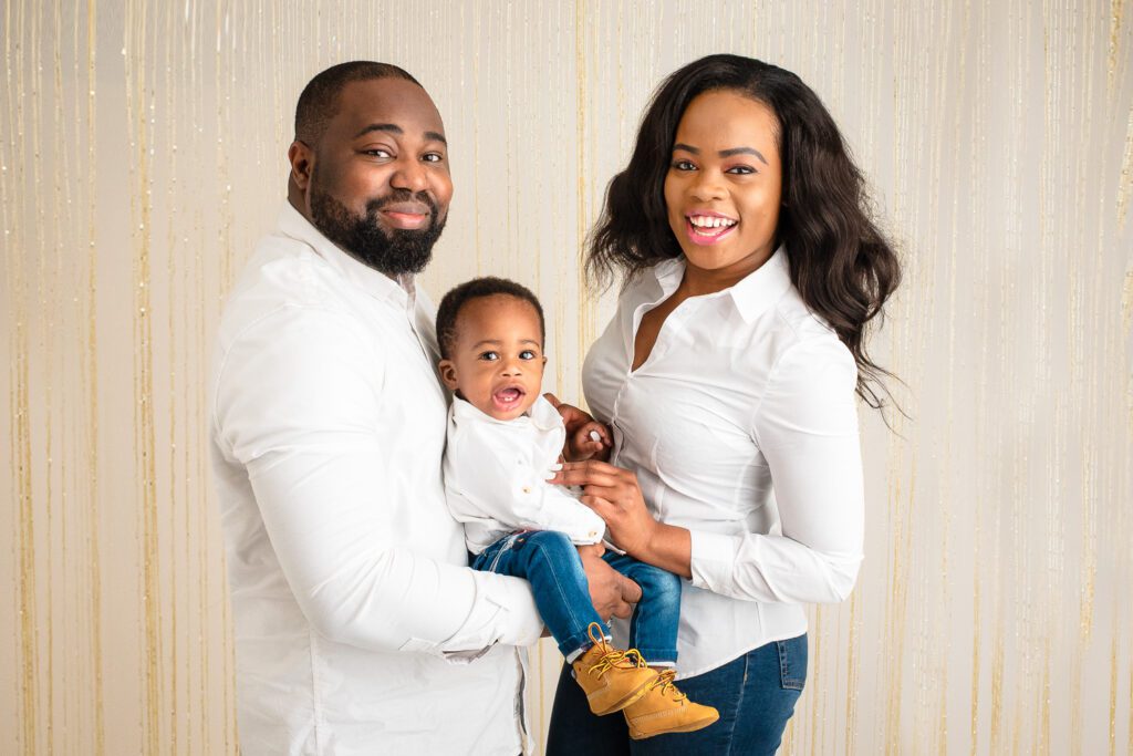 Mum and Dad holding their son during photoshoot