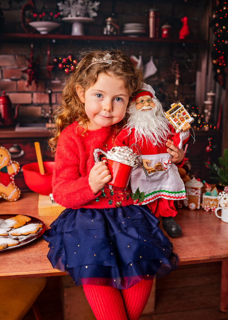 Girl holding a hot chocolate and Santa during a Christmas Photoshoot with Ola Molik Photography in Glasgow